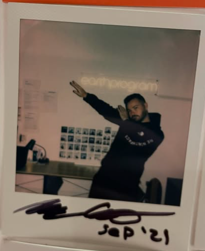 Polaroid of Mark dabbing in the office, signed and dated Sep '21